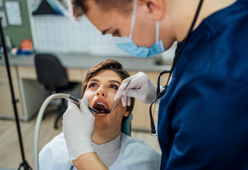 Dentist performing root canal treatment on patient in a dental office in Springboro, OH